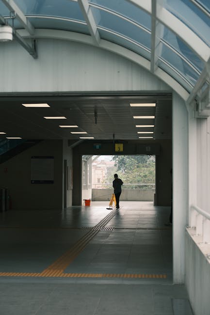 Four white tiles with black letters spelling 'HTML' are arranged in a horizontal line on a smooth, coral-colored surface. The tiles are evenly spaced, with clean and sharp edges, and the surface appea